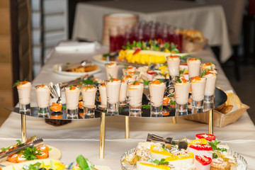 seafood sauce in shot glasses on a tray on a table, selective focus