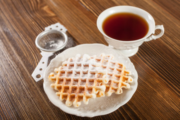 Wafers and tea on a table, selective focus