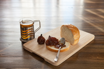 fig jam sandwich and tea on a table, selective focus