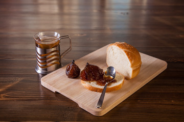 fig jam sandwich and tea on a table, selective focus