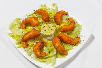 cooked shrimps served on white plate