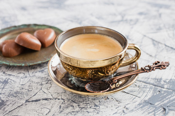 cup of coffee and candies on a table, selective focus