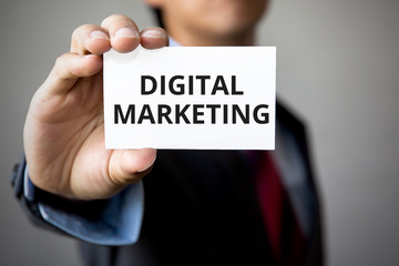 Businessman presenting 'Digital Marketing' word on white card