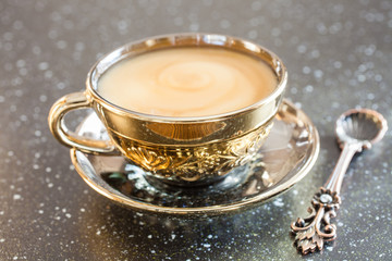 coffee with milk in a cup on a table, selective focus