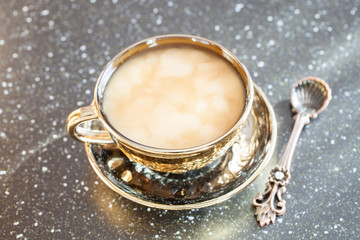 coffee with milk in a cup on a table, selective focus