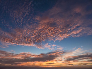 Sunset over the Atlantic Ocean composing a dramatic orange cloud