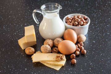 milk, cheese, eggs and nuts on a table, selective focus