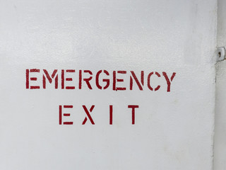 Emergency exit signpost on a ship.