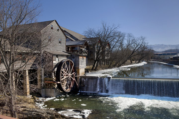 Watermill on the Little Pigeon river, in the mountain community of Pigeon Forge, Tennessee during the winter. Ice can be seen along the banks of the river
