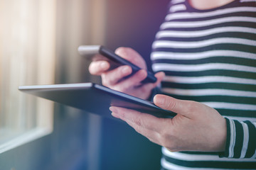 Smartphone and tablet data synchronization, woman syncing files