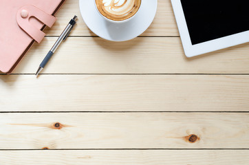 Office desk table with tablet, coffee cup ,pen and notebook.Top view with copy space