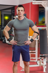 Portrait of muscular man with arms crossed in crossfit gym