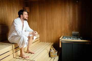 Handsome man relaxing in sauna