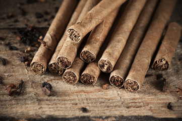 Cigars pile on wood
