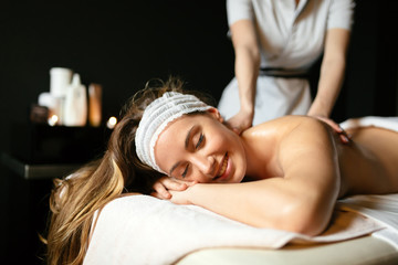 Obraz na płótnie Canvas Beautiful woman enjoying massage treatment