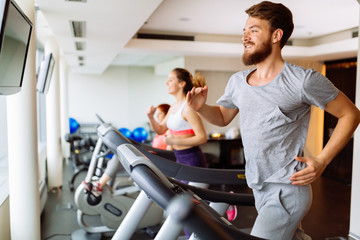 People running on treadmill in gym