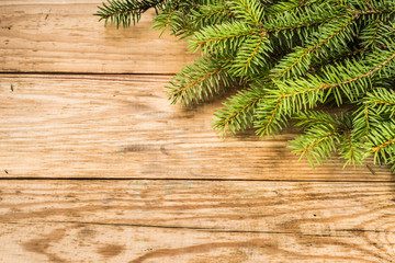 Branches of fir, christmas background, rustic wooden boards with copy space