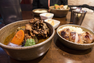 Soup Curry Chicken and Vegetables Bowl in Sapporo, Hokkaido, Japan 