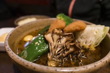 Soup Curry Chicken and Vegetables Bowl in Sapporo, Hokkaido, Japan 