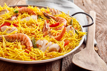 Seafood Paella Served in Metal Pan with Wood Spoon