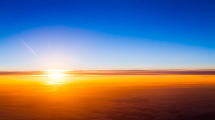 Fototapeta premium Sunset scene. Sunset above the clouds