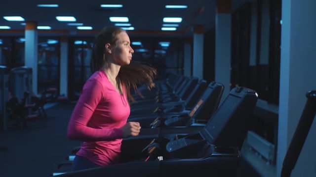 Girl working out in a treadmill at the gym