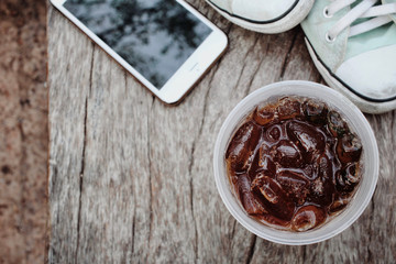 Cola with smart phone and sneakers