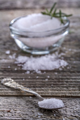 salt in the spoon on the old rustic table