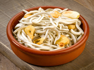 mud pie plate with fried baby eels with garlic