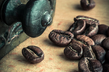 Macro closeup photo of roasted coffee beans laying on the wooden table. Natural coffee beans. Black coffee seeds. Brown aroma composition of coffee beans flavor.