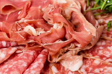 Closeup of prosciutto and salami italian platter.