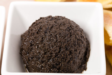 Tapenade of black olives as a appetizer.