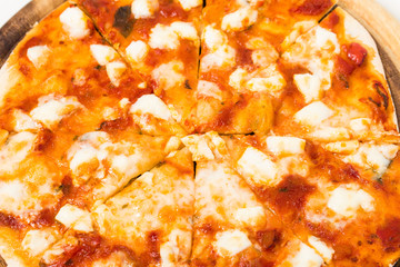 Closeup of melted cheese on sliced pizza.