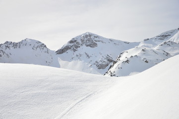 Fototapeta na wymiar Winter snow covered mountain peaks in Europe