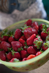Fresh organic strawberries in the green bowl. Healthy snack. Berries for lunch. Ingredients for fruit salad.