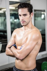 Obraz premium Serious shirtless man with arms crossed