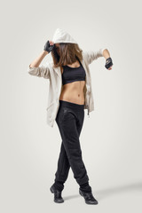 Confident girl dancer wearing sports jacket stands