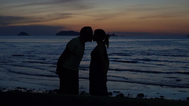 Young couple in love, kissing on beach during sunset,4K
