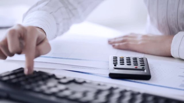 accountant making calculations and working with computer