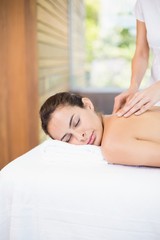 Obraz na płótnie Canvas Beautiful young woman receiving massage