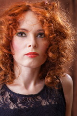 Fototapeta premium Portrait of beautiful woman with long curly red.