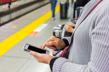 Close up of a woman using mobile smart phone.