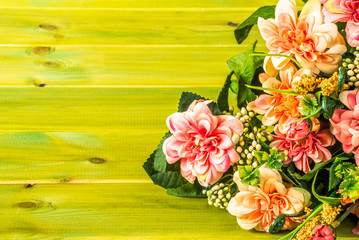 Mixed flowers bouquet on wood background.