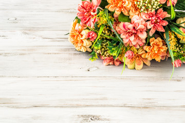 Mixed flowers bouquet on wood background.