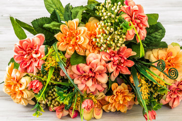 Mixed flowers bouquet on wood background.