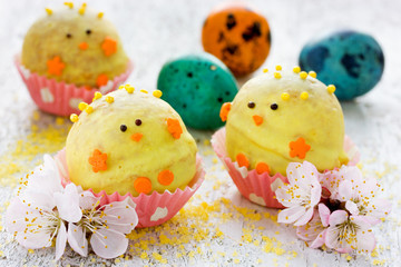 Easter dessert candy in shape of yellow chick in chocolate