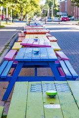 Line of Colorful Picnic Tables