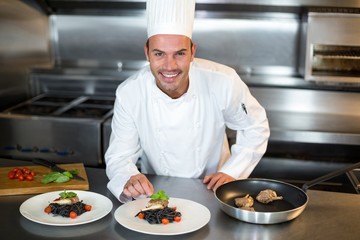 Chef putting finishing touch on dish