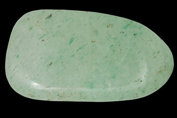 pebble of green quartz macro, isolated on black background