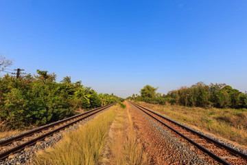Fototapeta na wymiar Railway tracks with blue sky in the evening